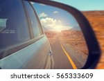 Reflection of the highway in a car mirror. Toned photo. Road travel concept.