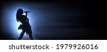 singer under the glowing blue... | Shutterstock .eps vector #1979926016