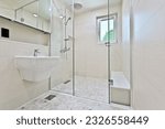 Small photo of A bathroom with a glass partition separating the shower area