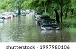 Small photo of Flooded cars on the street of the city. Street after heavy rain. Water could enter the engine, transmission parts or other places. Disaster Motor Vehicle Insurance Claim Themed. Severe weather concept