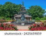Small photo of St. Cloud, Minnesota USA July 11, 2022 Renaissance Fountain with Cranes - Dedicated 1999, Bronze figures, top sculpture of Hebe, cup Bearer to the Gods; four bathing boys below at Clemens Gardens.