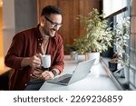 Confident businessman executive coach in casual clothes using laptop computer, having video conference call virtual meeting, professional training negotiation, remote working from home.