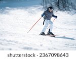 Confident skier skiing downhill ...