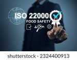 Small photo of Businessman pointing to the ISO 22000 Food safety quality assurance mark to show that the management system in the production and storage process has been certified by the auditor or certified body.