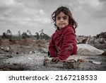 Small photo of KANI QIRZHALA, IRAQ - FEBRUARY 25, 2016: an internally displaced girl who fled fighting between Iraqi forces and Islamic State militants waits for her mother to finish work at Kani Qirzhala landfill.