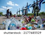 Small photo of San Antonio, TexasUnited States - July 1, 2022: A makeshift memorial at the site where more than 50 migrants were found in a tractor trailer continues to grow on the southwest side of San Antonio