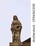 Small photo of Torre di Ruggiero, Calabria, Italy - March 5 2021: Virtue of Charity Statue on the Exterior of the Sanctuary "Santa Maria delle Grazie"