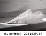 White Paper Plane Lie On...