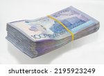Small photo of A pack of ten thousand banknotes of the national currency of Kazakhstan on an isolated white background.One million tenge for 100000 tenge. A wad of money.