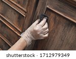 Small photo of close up female hand painting an old vintage piece of furniture with a brown patina