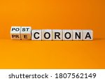 Hand turns cubes and changes the expression 'pre corona' to 'post corona'. Covid-19 pandemic concept. Beautiful orange background. Copy space.