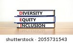 Small photo of DEI, Diversity, equity, inclusion symbol. Books with words DEI, diversity, equity, inclusion on beautiful wooden table, white background. Business, DEI, diversity, equity, inclusion concept.