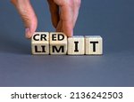 Small photo of Credit limit symbol. Businessman turns wooden cubes and changes the word 'limit' to 'credit'. Beautiful grey table, grey background, copy space. Business and credit limit concept.