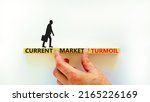 Small photo of Current market turmoil symbol. Concept words Current market turmoil on wooden blocks on a beautiful white table white background. Businessman hand. Business, finacial current market turmoil concept.