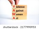 Small photo of VAWA violence against women act symbol. Concept words VAWA violence against women act on blocks. Beautiful white background. Business, motivational VAWA violence against women act concept.