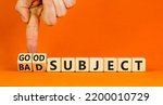Small photo of Good or bad subject symbol. Businessman turns wooden cubes and changes the word bad subject to good subject. Beautiful orange background. Business, good or bad subject concept. Copy space.