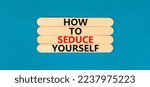 Small photo of How to seduce yourself symbol. Concept word How to seduce yourself on wooden sticks. Beautiful blue table blue background. Business and how to seduce yourself concept. Copy space.