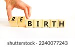 Small photo of Birth or rebirth symbol. Businessman turns wooden cubes and changes the word birth to rebirth. Beautiful white table white background, copy space. Business, birth or rebirth concept.