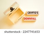 Small photo of Crypto downfall symbol. Concept words Cryptos downfall on wooden blocks. Beautiful white table white background. Wooden empthy chest. Business and crypto downfall concept. Copy space.
