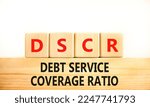 Small photo of DSCR debt service coverage ratio symbol. Concept words DSCR debt service coverage ratio on wooden block on beautiful white background. Business DSCR debt service coverage ratio concept. Copy space.