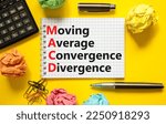 Small photo of MACD symbol. Concept words MACD moving average convergence divergence on white note on beautiful yellow background. Business MACD moving average convergence divergence concept. Copy space.