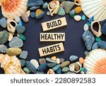Small photo of Motivation and Build healthy habits symbol. Concept words Build healthy habits on wooden block on a beautiful black table black background. Business build healthy habits concept. Copy space.