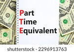 Small photo of PTE Part time equivalent symbol. Concept words PTE Part time equivalent on white note. Dollar bills. Beautiful background from dollar bills. Business and PTE Part time equivalent concept. Copy space.