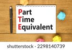 Small photo of PTE Part time equivalent symbol. Concept words PTE Part time equivalent on white note. Beautiful wooden table wooden background. Business and PTE Part time equivalent concept. Copy space.