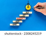 One size does not fit all symbol. Concept words One size does not fit all on wooden blocks. Businessman hand. Beautiful blue background. One size does not fit all business concept. Copy space.
