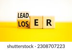 Small photo of Loser or leader symbol. Businessman turns wooden cubes and changes the word Loser to Leader. Beautiful yellow table white background. Business and loser or leader concept. Copy space.