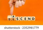 Small photo of Ascend or descend symbol. Concept words Ascend and Descend on wooden cubes. Beautiful orange table orange background. Businessman hand. Business ascend or descend concept. Copy space.