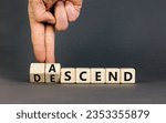 Small photo of Ascend or descend symbol. Concept words Ascend and Descend on wooden cubes. Beautiful grey table grey background. Businessman hand. Business ascend or descend concept. Copy space.