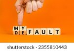Small photo of Default is my fault symbol. Concept words Default and My fault on wooden cubes. Beautiful orange table orange background. Businessman hand. Business default is my fault concept. Copy space.