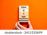 Small photo of Today is a new beginning symbol. Concept words Today is a new beginning on wooden blocks. Beautiful orange table orange background. Businessman hand. Business today new beginning concept. Copy space.