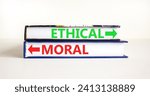 Small photo of Ethical or moral symbol. Concept word Ethical or Moral on beautiful books. Beautiful white table white background. Business and ethical or moral concept. Copy space.