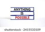 Small photo of Anything is possible symbol. Concept words Anything is possible on beautiful books. Beautiful white table white background. Business anything is possible concept. Copy space.