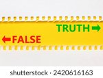Small photo of Truth or false symbol. Concept word Truth or False on beautiful yellow paper. Beautiful white paper background. Business and truth or false concept. Copy space.