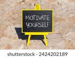 Motivate yourself symbol. Concept words Motivate yourself on beautiful black chalk blackboard. Chalkboard. Beautiful stone background. Business psychology motivate yourself concept. Copy space.