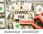 Small photo of A chance for change symbol. Concept words A chance for change on beautiful wooden block. Beautiful dollar bills background. Voter hand. Dollar bills. Business A chance for change concept. Copy space.