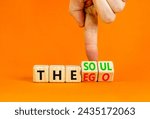 Small photo of Soul or ego symbol. Concept word The soul or The ego on beautiful wooden cubes. Beautiful orange table orange background. Psychologist hand. Psychological soul or ego concept. Copy space.