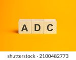 Small photo of ADC, questions and answers on wooden cubes. Concept