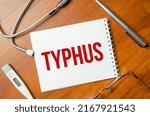 Small photo of sheet of paper with the text typhus and stethoscope. Medical concept