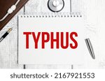 Small photo of typhus word on white notebook and pen with stethoscope