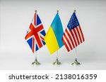 National flags of Great Britain, USA and Ukraine on a light background.