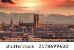 Small photo of Sunrise over Munich Germany city, munich skyline aerial view in background pre alps mountains colored sky frauenkirche church cathedral marienplatz.