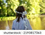 Small photo of Girl's first Holy Communion, hands folded in prayer. White communion dress, rosary and prayer books, a wreath on the head
