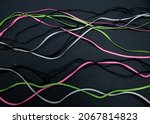 Small photo of lines, wire, colored wires, black background, pink wire, gray wire, green wire, gadgets.