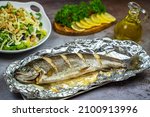 Oven baked trout in foil and salad. 
