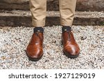 Elegant and hipster groom's shoes with cool socks. Wedding photography concept. Selective focus.j