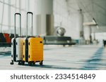 Small photo of Two suitcases in an empty airport hall, traveler cases in the departure airport terminal waiting for the area, vacation concept, blank space for text message or design
